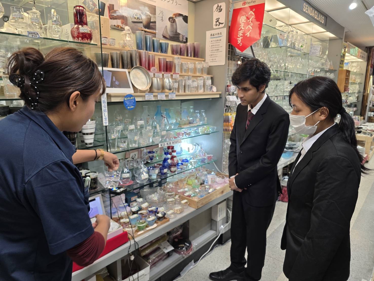 店内に並ぶ商品について説明を受けるエール学園の学生の皆さん
